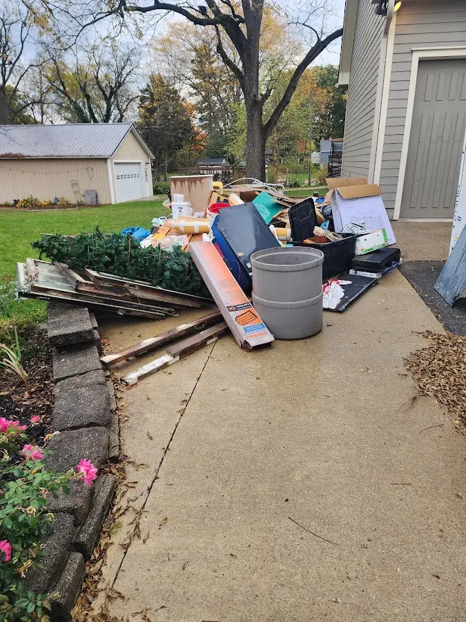 Dumpster being loaded with debris for Commercial Dumpster Rental in Rochester